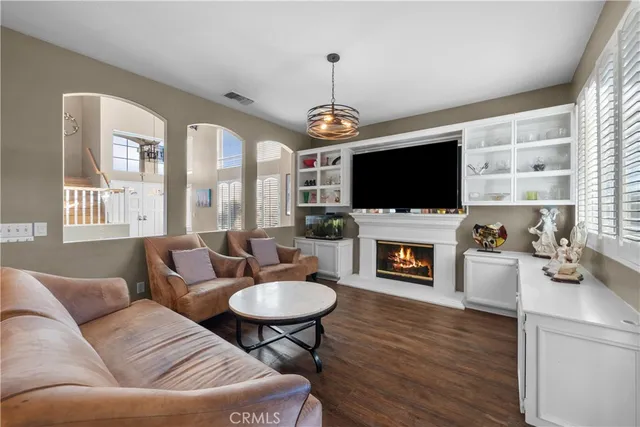 a living room with furniture a fireplace and a flat screen tv