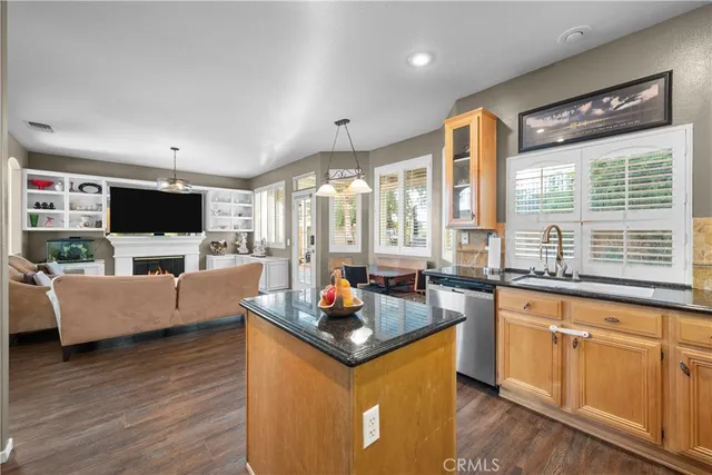 a living room with furniture flat screen tv and large windows