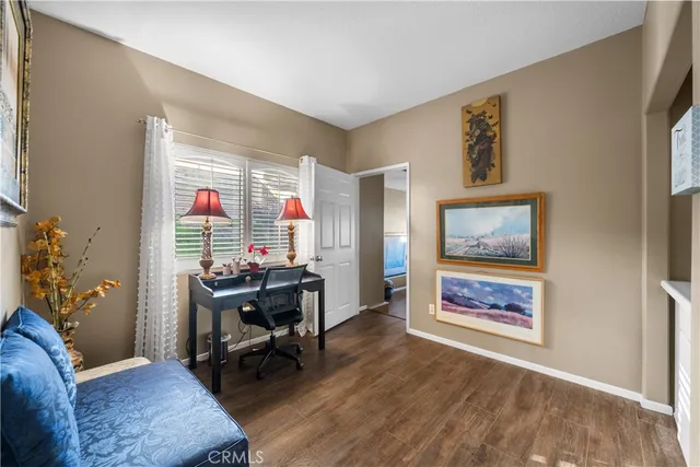 a view of a workspace with furniture and a window