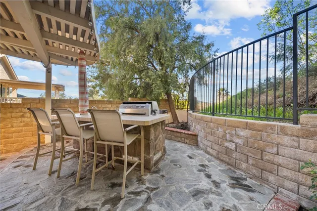 a view of a porch with a table and chairs