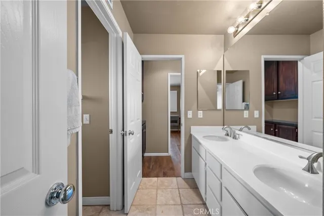 a spacious bedroom with a large bed and a chandelier