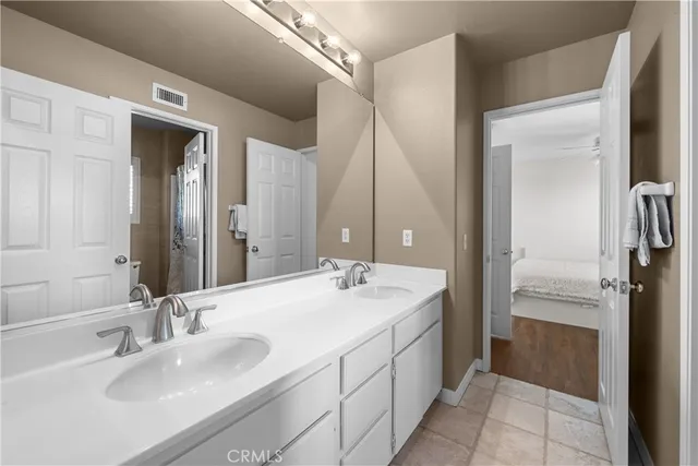 a spacious bedroom with a bed and a large window