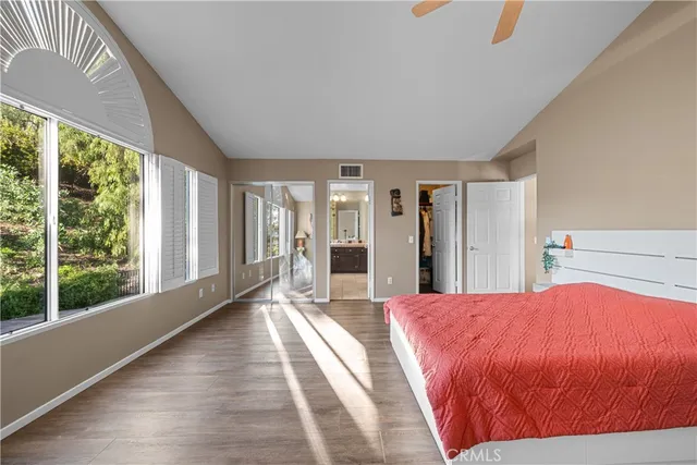 a spacious bathroom with a double vanity sink a mirror and a bathtub
