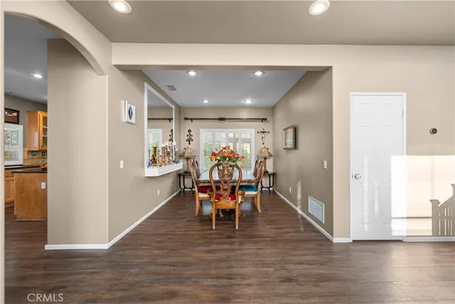 a dining room with furniture and wooden floor