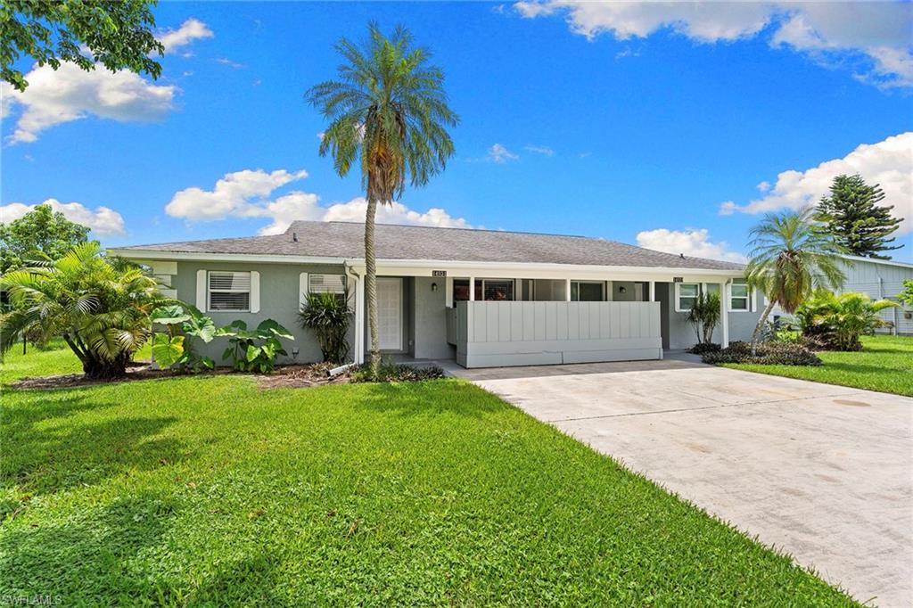 14929 Wise Way, Unit 931 Fort Myers, FL 33905 - Photo 1 of 39 a front view of a house with a garden and yard
