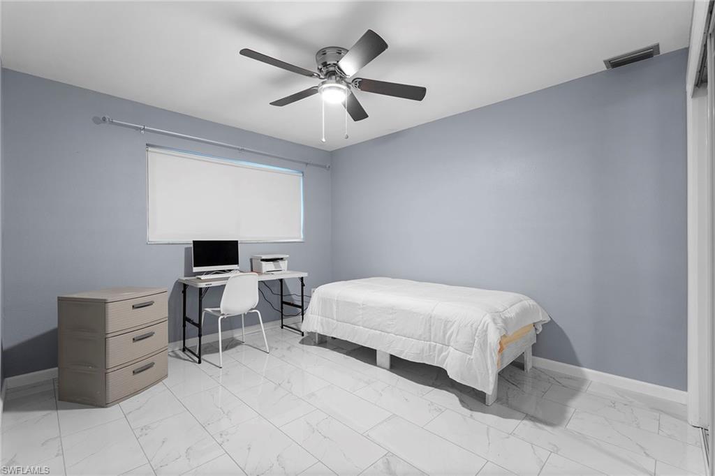 14929 Wise Way, Unit 931 Fort Myers, FL 33905 - Photo 11 of 39 a bedroom with a bed and a desk