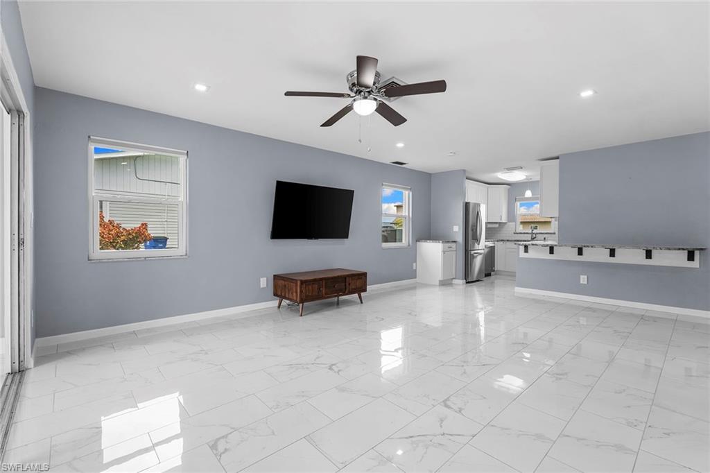 14929 Wise Way, Unit 931 Fort Myers, FL 33905 - Photo 8 of 39 a view of living room with furniture and a flat screen tv