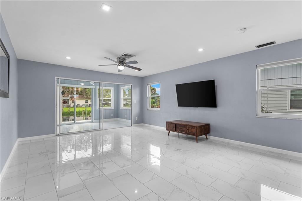 14929 Wise Way, Unit 931 Fort Myers, FL 33905 - Photo 9 of 39 a living room with furniture and a flat screen tv