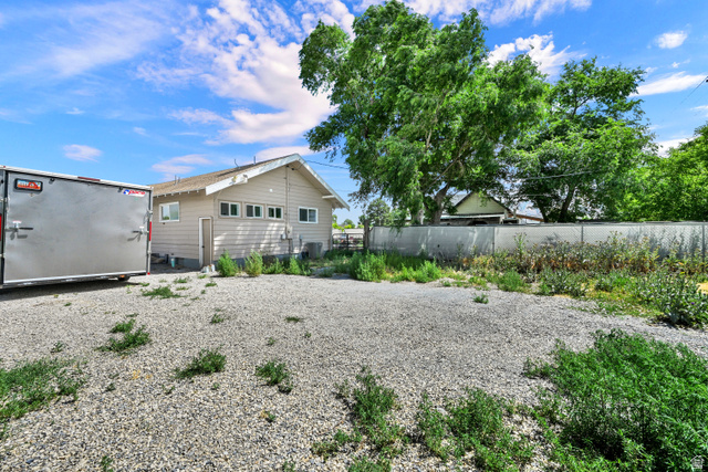 716 East Factory Street Garland, UT 84312 - Photo 30 of 30 Property exterior featuring horizontal siding, multiple windows, and a side entrance