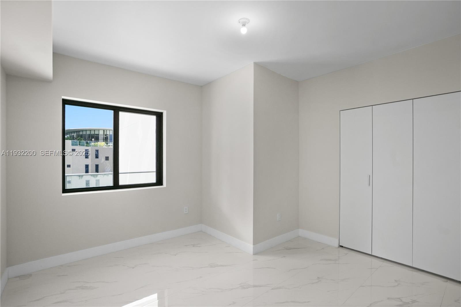 700 Northeast 24th Street, Unit 602 Miami, FL 33137 - Photo 11 of 39 an empty room with windows and closet