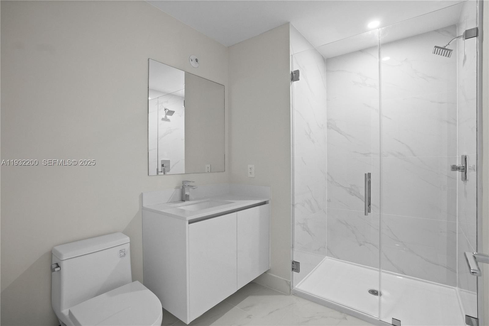 700 Northeast 24th Street, Unit 602 Miami, FL 33137 - Photo 13 of 39 a bathroom with a granite countertop sink toilet and shower