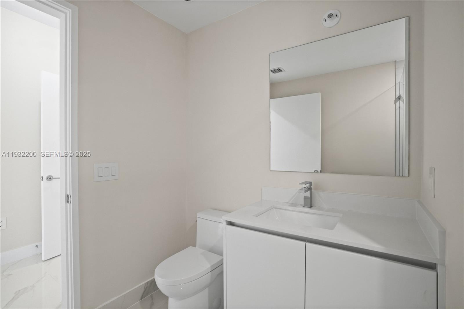 700 Northeast 24th Street, Unit 602 Miami, FL 33137 - Photo 14 of 39 a bathroom with a sink toilet and a mirror
