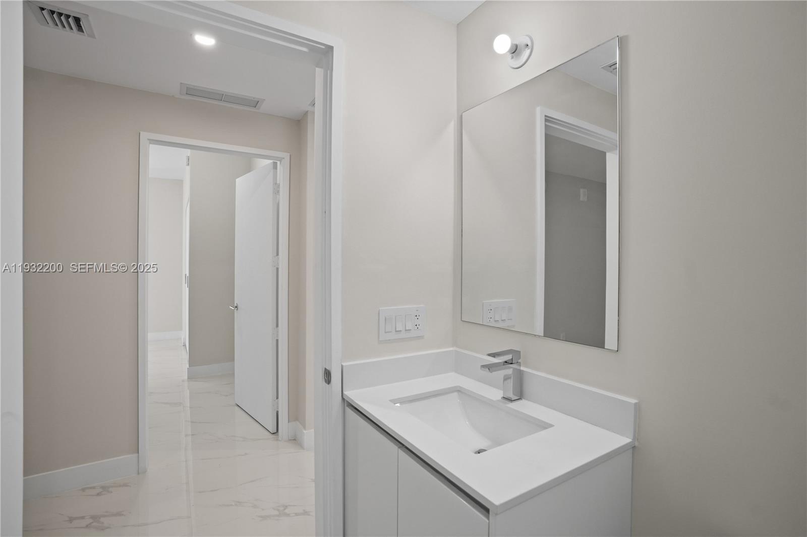 700 Northeast 24th Street, Unit 602 Miami, FL 33137 - Photo 17 of 39 a bathroom with a sink and a mirror