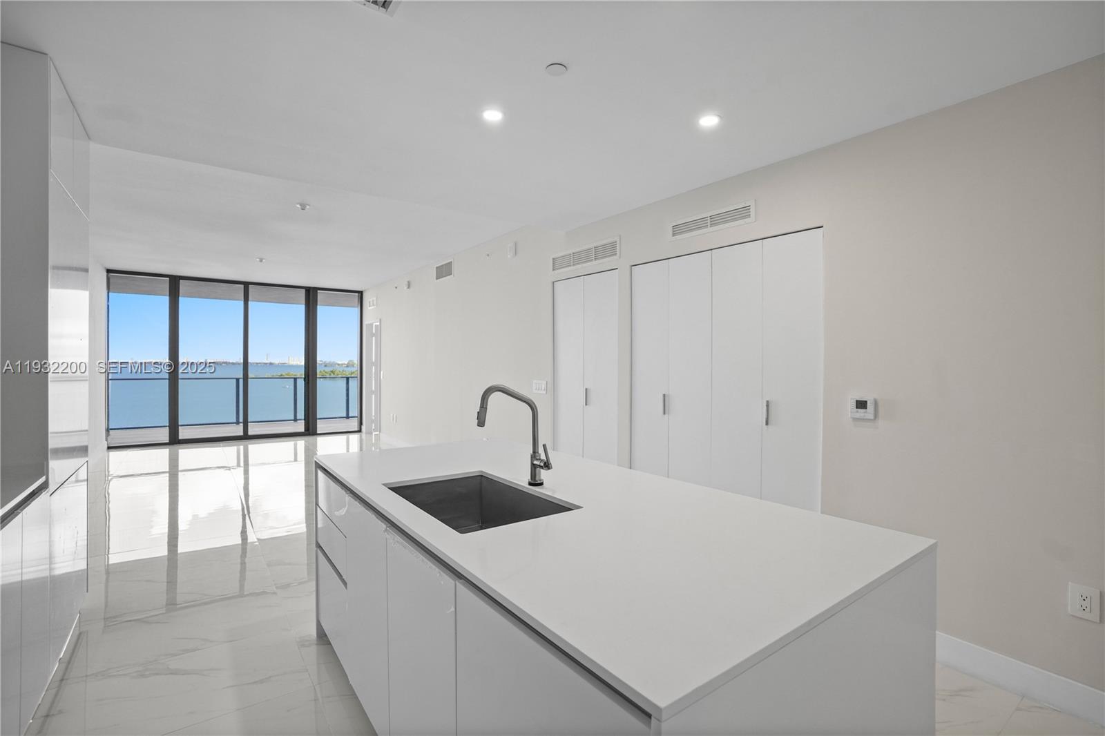 700 Northeast 24th Street, Unit 602 Miami, FL 33137 - Photo 21 of 39 a kitchen with a sink and white cabinets