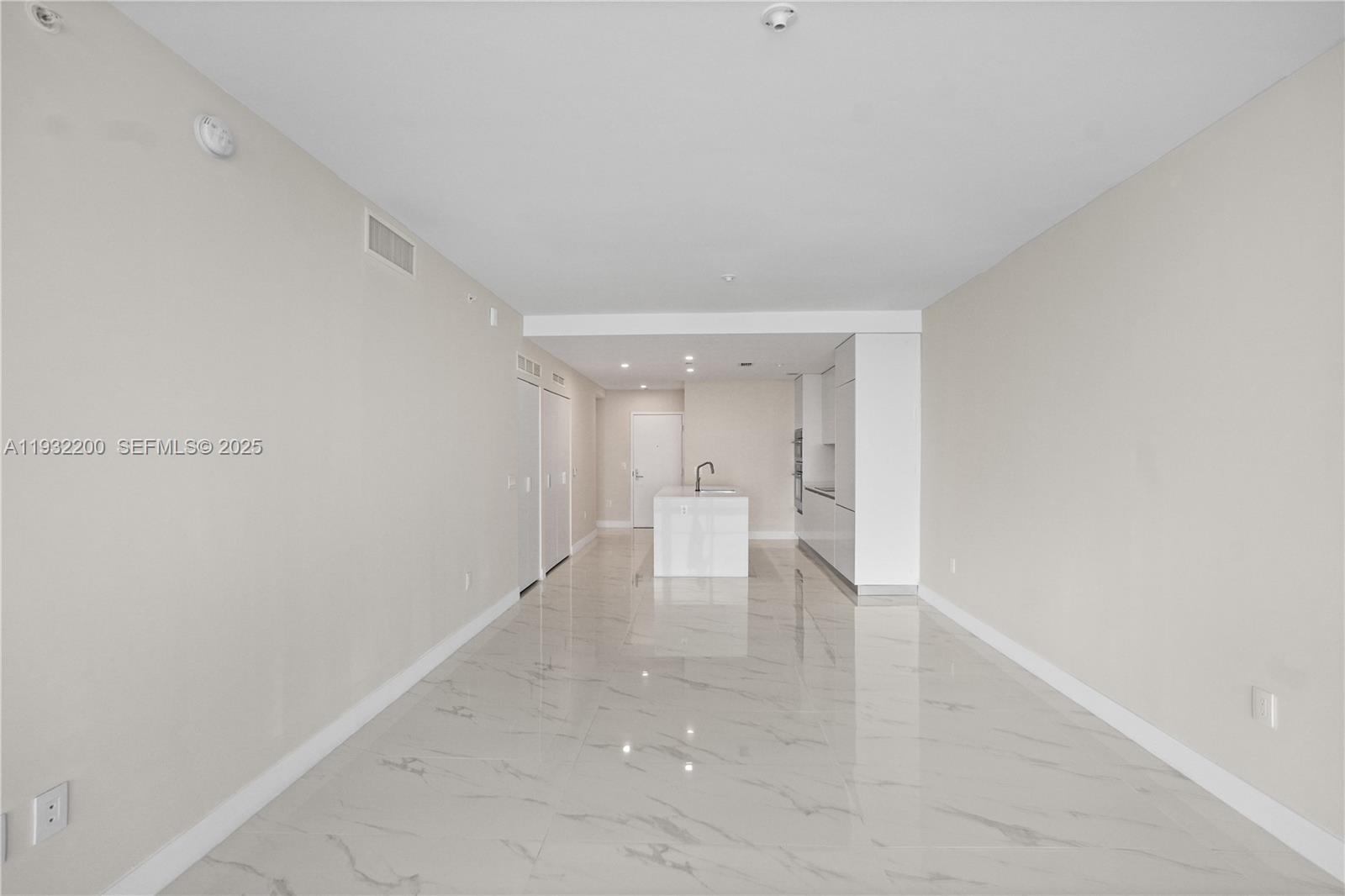 700 Northeast 24th Street, Unit 602 Miami, FL 33137 - Photo 26 of 39 a view of an empty room with wooden floor and a window
