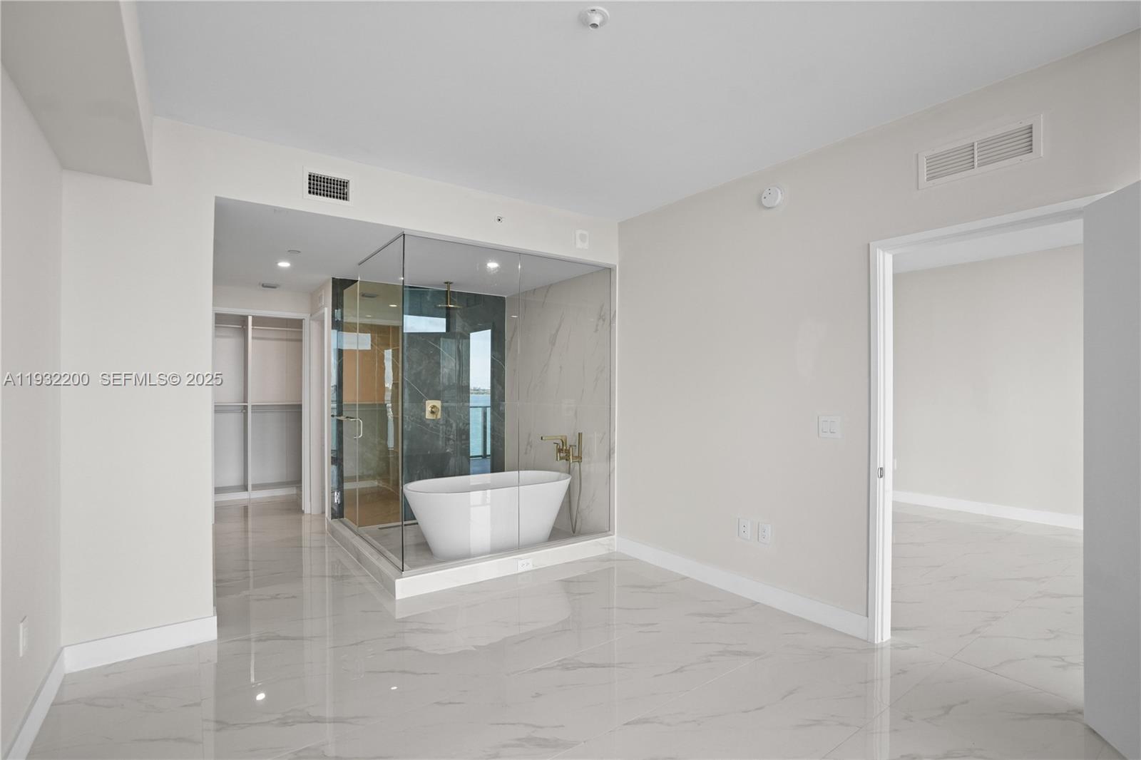 700 Northeast 24th Street, Unit 602 Miami, FL 33137 - Photo 28 of 39 a large white bathroom with a glass shower door