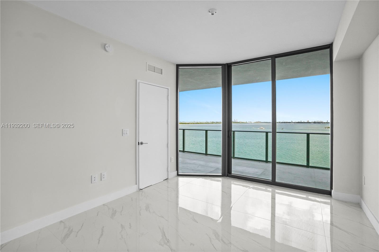 700 Northeast 24th Street, Unit 602 Miami, FL 33137 - Photo 29 of 39 a view of an empty room with a sliding door
