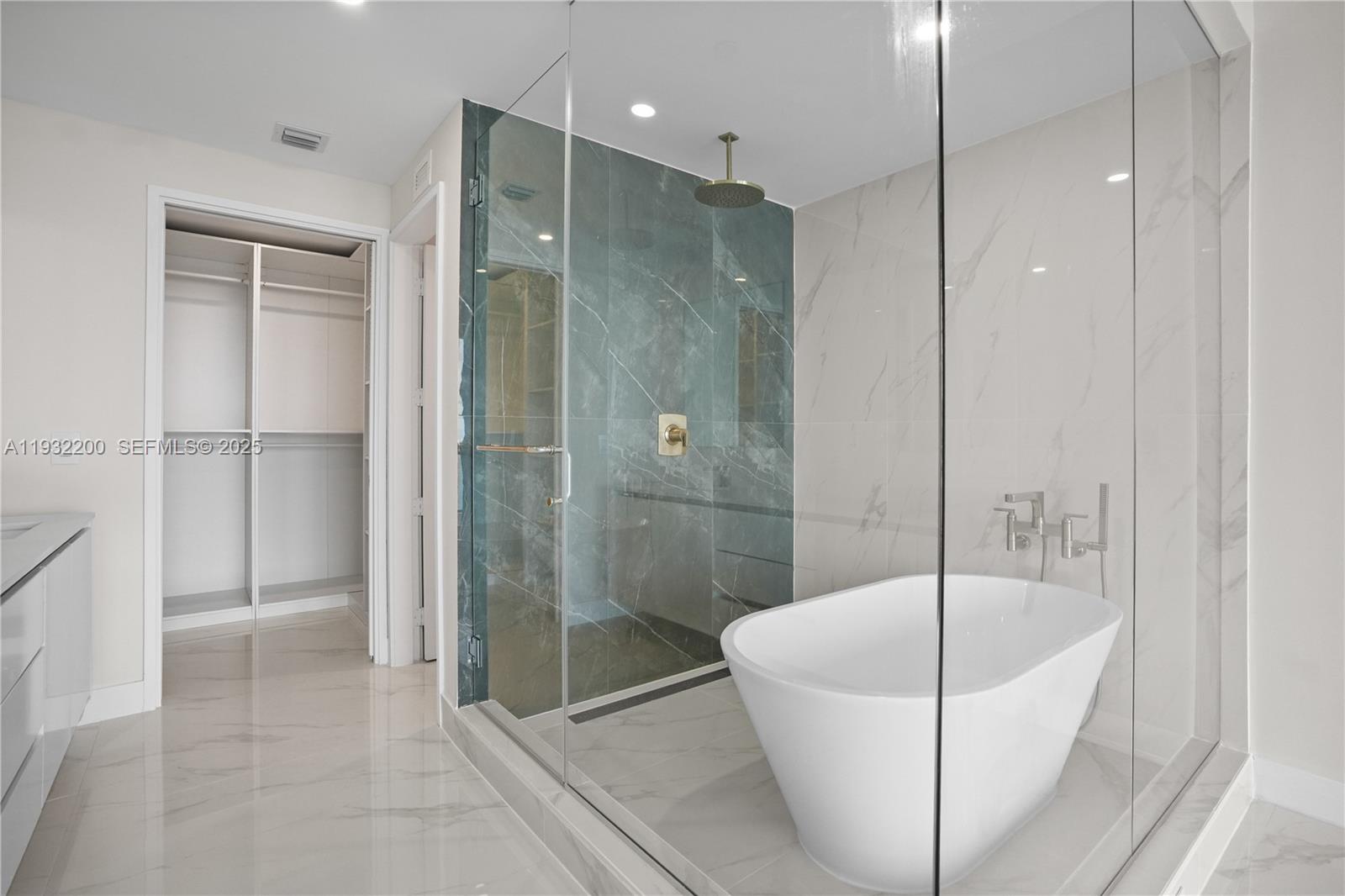 700 Northeast 24th Street, Unit 602 Miami, FL 33137 - Photo 30 of 39 a bathroom with a bathtub and a shower