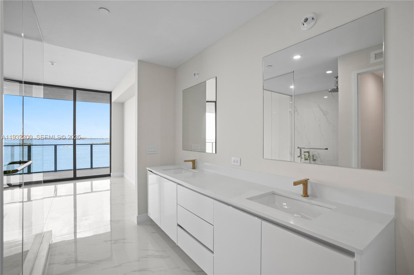 700 Northeast 24th Street, Unit 602 Miami, FL 33137 - Photo 32 of 39 a bathroom with a sink double vanity and a shower