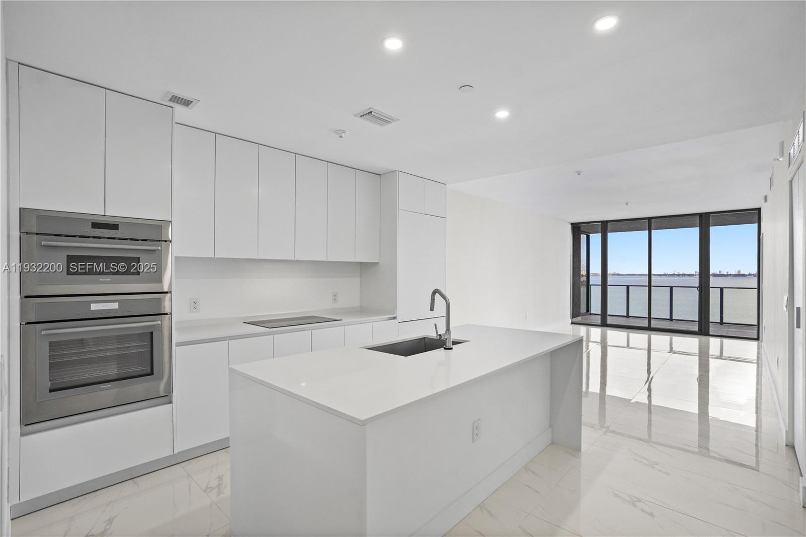 700 Northeast 24th Street, Unit 602 Miami, FL 33137 - Photo 6 of 39 a kitchen that has a sink and a stove