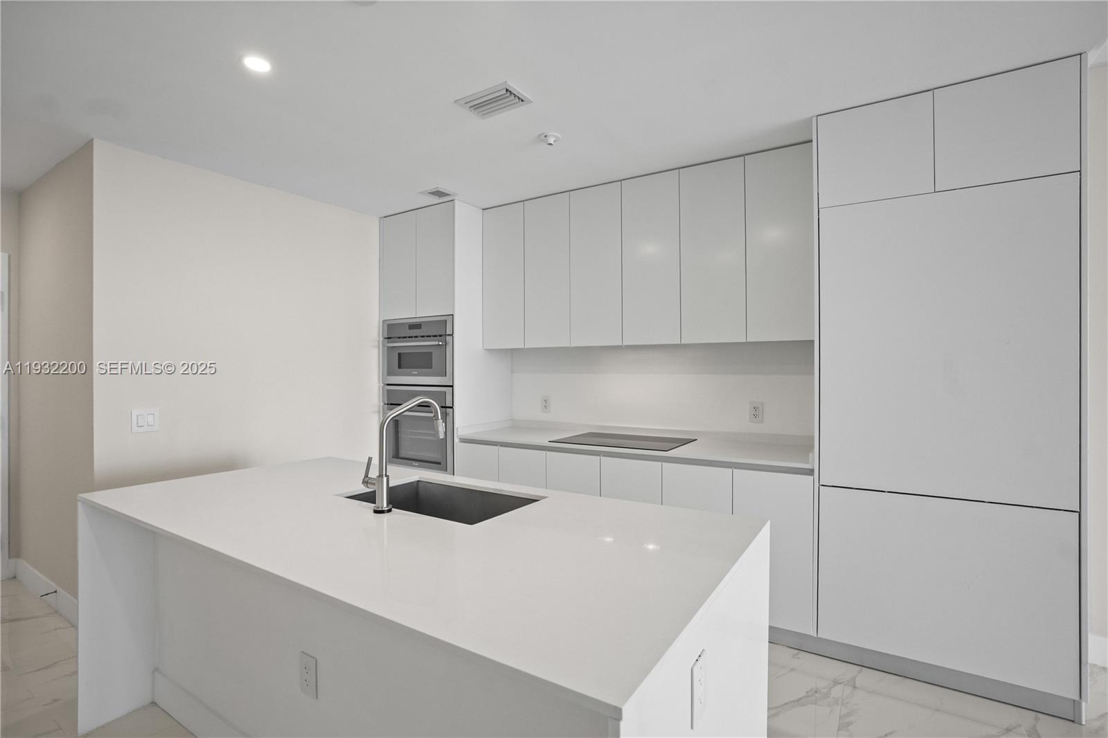 700 Northeast 24th Street, Unit 602 Miami, FL 33137 - Photo 8 of 39 a kitchen with a sink stainless steel appliances and cabinets