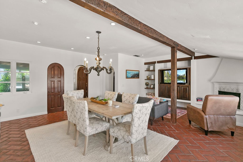 52 Emerald Bay Laguna Beach, CA 92651 - Photo 11 of 31 a dining room with furniture a chandelier and wooden floor