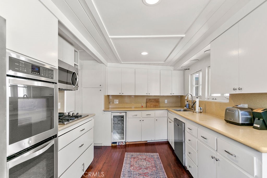 52 Emerald Bay Laguna Beach, CA 92651 - Photo 14 of 31 a kitchen with a sink stainless steel appliances and cabinets