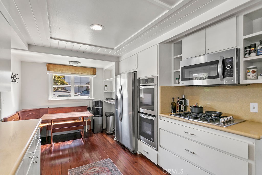 52 Emerald Bay Laguna Beach, CA 92651 - Photo 15 of 31 a kitchen with stainless steel appliances a stove a microwave and a refrigerator