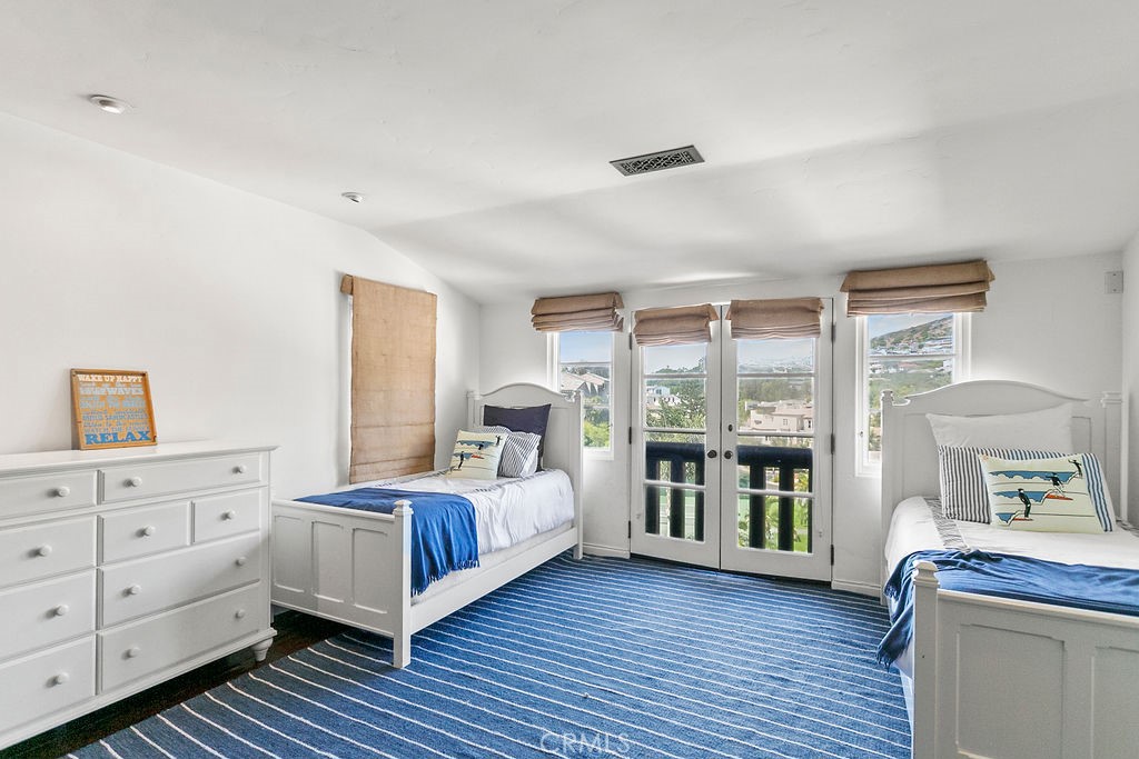 52 Emerald Bay Laguna Beach, CA 92651 - Photo 17 of 31 a bedroom with a bed and a window