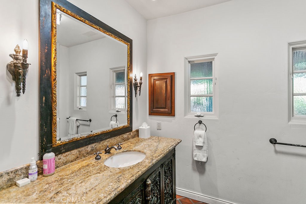 52 Emerald Bay Laguna Beach, CA 92651 - Photo 19 of 31 a bathroom with a granite countertop sink and a mirror