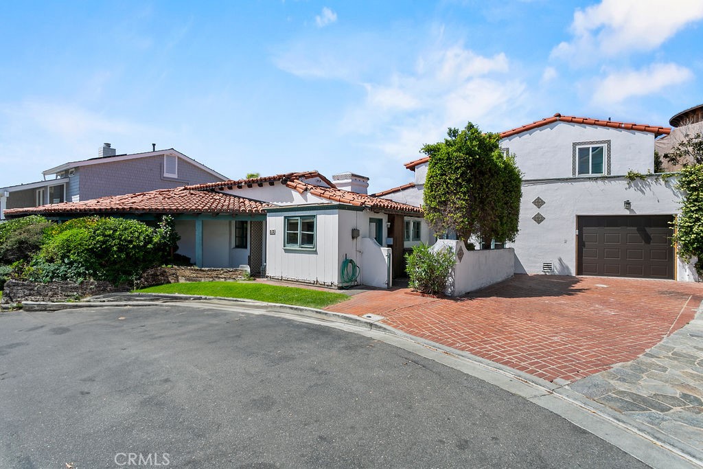 52 Emerald Bay Laguna Beach, CA 92651 - Photo 2 of 31 a front view of a house with a yard and garage