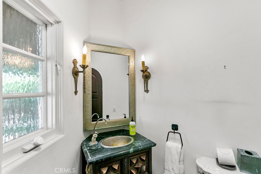 52 Emerald Bay Laguna Beach, CA 92651 - Photo 21 of 31 a bathroom with a sink and a mirror