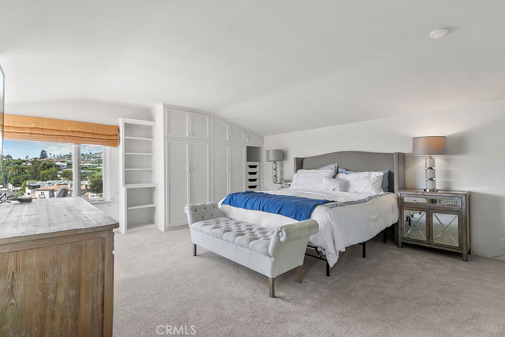 52 Emerald Bay Laguna Beach, CA 92651 - Photo 22 of 31 a bedroom with a bed and a large window