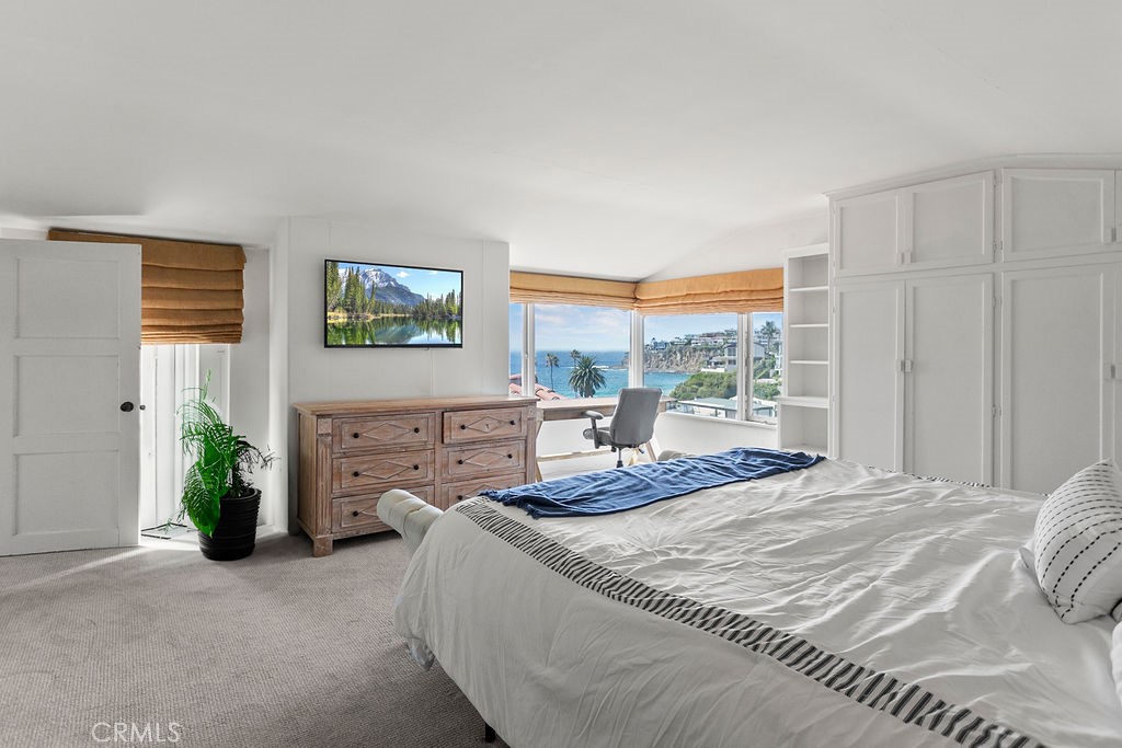 52 Emerald Bay Laguna Beach, CA 92651 - Photo 23 of 31 a bedroom with a bed and a window