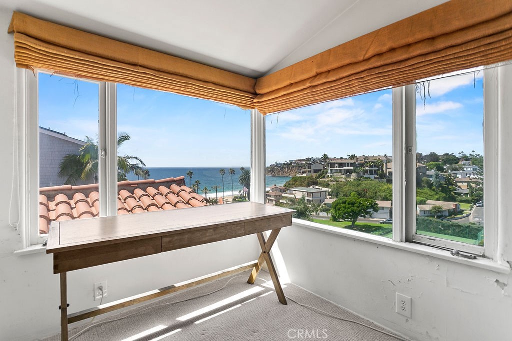 52 Emerald Bay Laguna Beach, CA 92651 - Photo 24 of 31 a room with a large window and a table chair