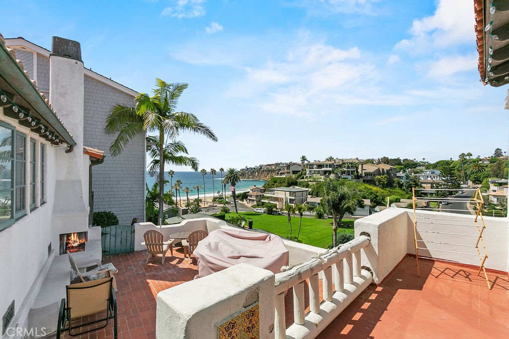 52 Emerald Bay Laguna Beach, CA 92651 - Photo 26 of 31 a view of a chairs and table in patio with a lake view
