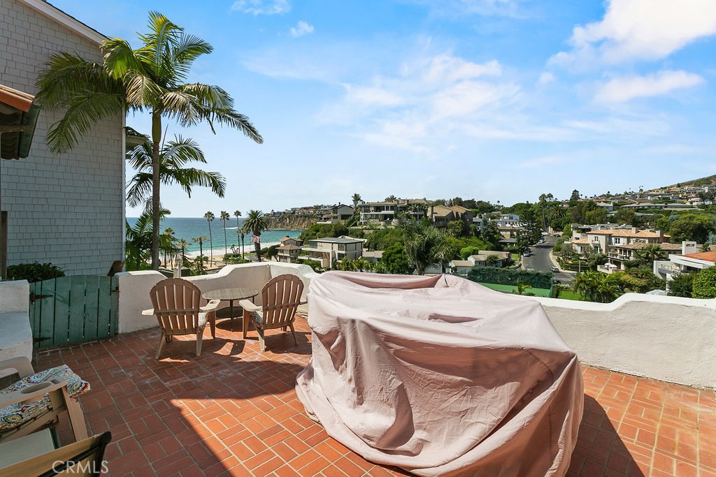 52 Emerald Bay Laguna Beach, CA 92651 - Photo 27 of 31 a view of a patio with couches table and chairs under an umbrella