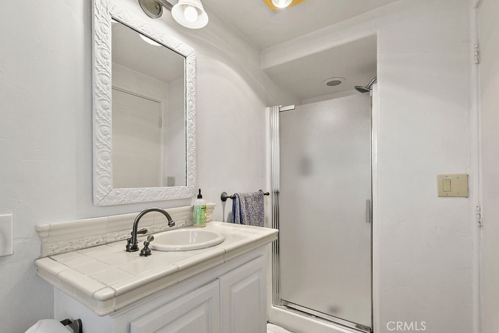 52 Emerald Bay Laguna Beach, CA 92651 - Photo 31 of 31 a bathroom with a sink and a mirror