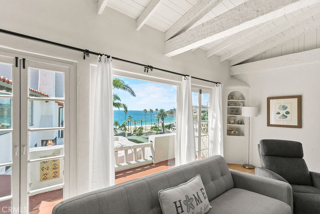 52 Emerald Bay Laguna Beach, CA 92651 - Photo 8 of 31 a living room with furniture and a large window with garden view