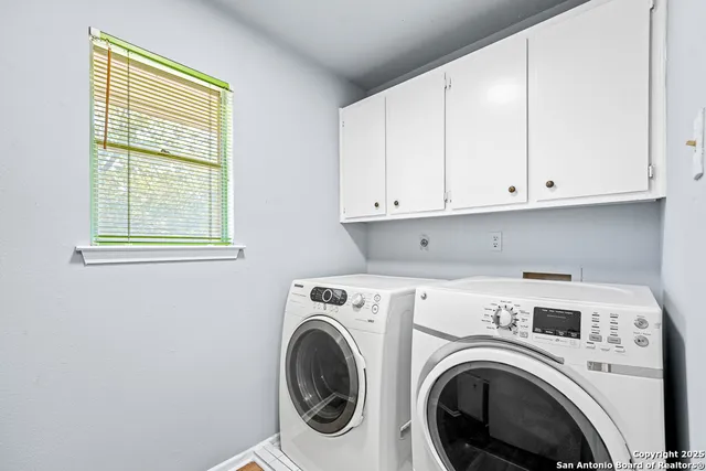 a view of storage and utility room with washer and dryer