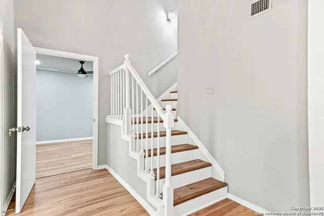 a view of a hallway with wooden floor and entryway