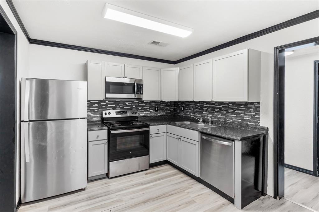 2802 Spring Valley Drive Bedford, TX 76021 - Photo 6 of 24 a kitchen with a refrigerator stove and microwave