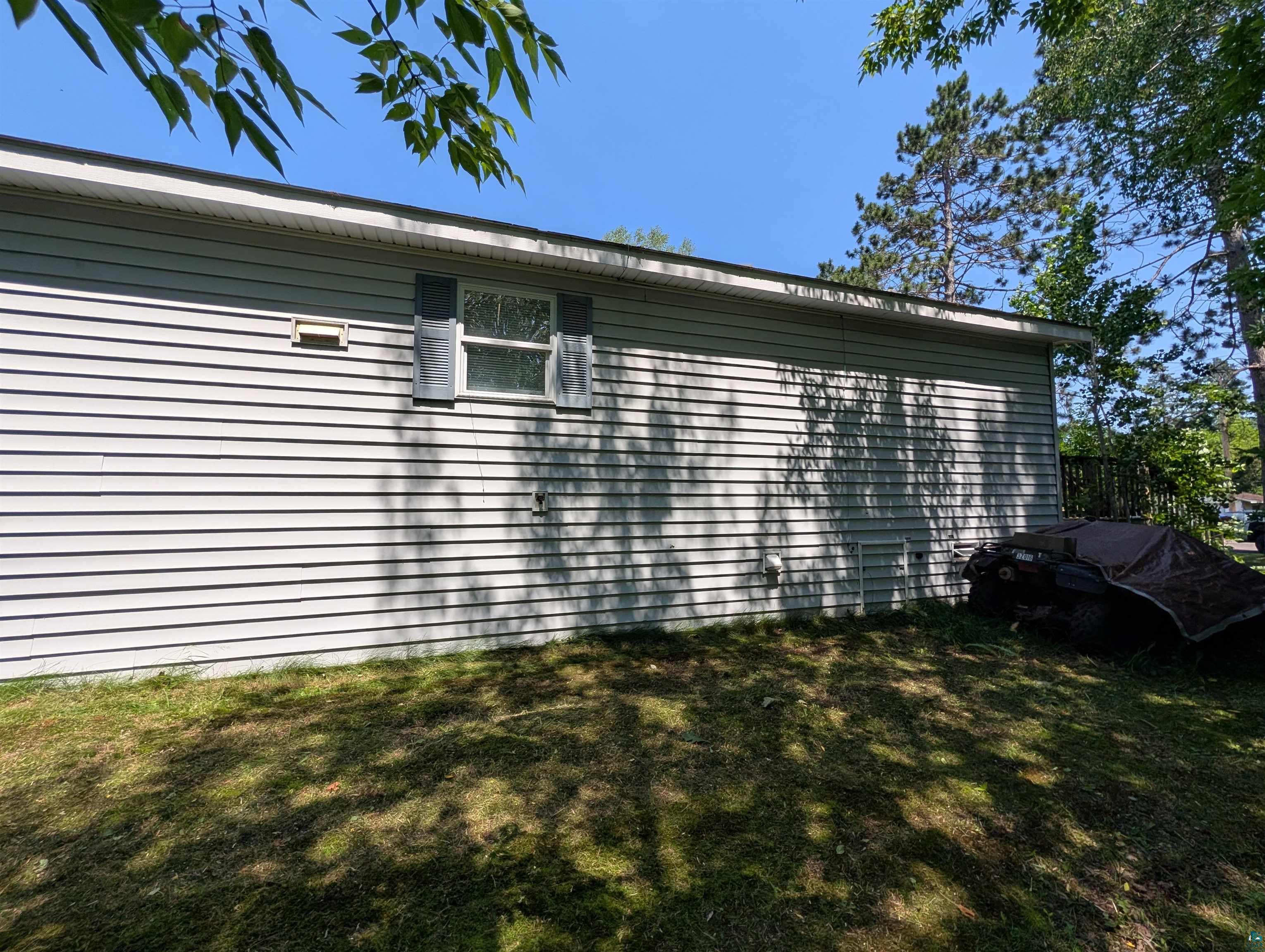 3945 Maple Street Kettle River, MN 55757 - Photo 39 of 41 Light-toned horizontal siding with a single window featuring dark shutters