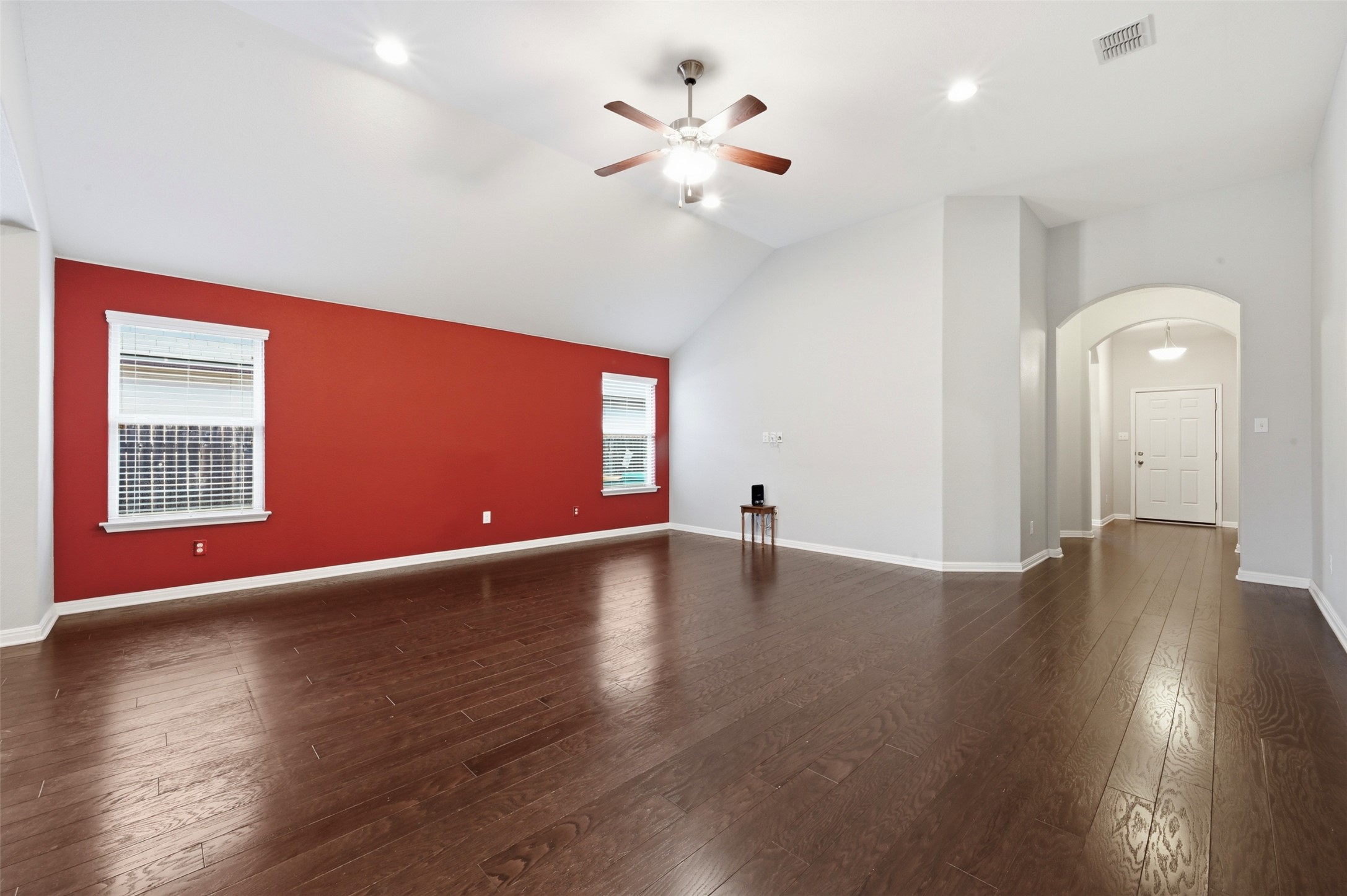 13116 Alans Way Manchaca, TX 78652 - Photo 7 of 25 Spacious living area featuring wood-finish flooring, a vaulted ceiling, recessed lighting, and a ceiling fan