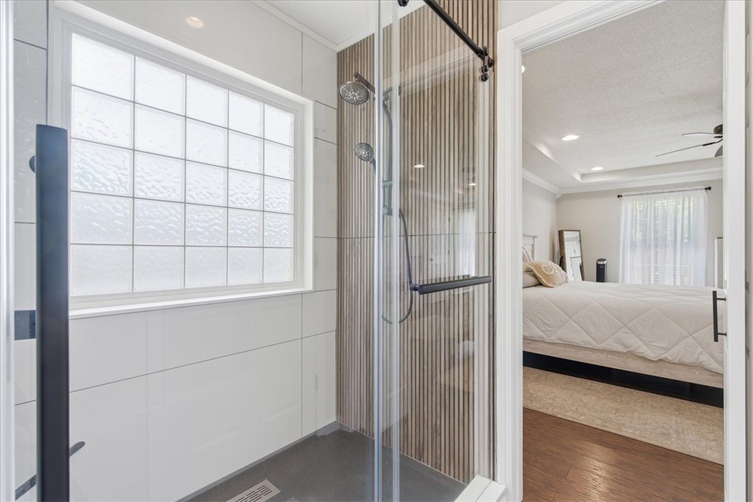 166 Amberwood Drive Anderson, SC 29621 - Photo 17 of 38 This bright bathroom features a glass-enclosed shower, complemented by an adjoining bedroom with a unique ceiling.