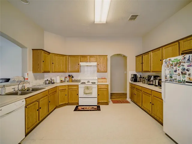 a kitchen with a sink stove and refrigerator