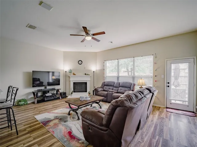 a living room with furniture fireplace and a flat screen tv