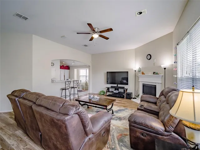 a living room with furniture a fireplace and a flat screen tv