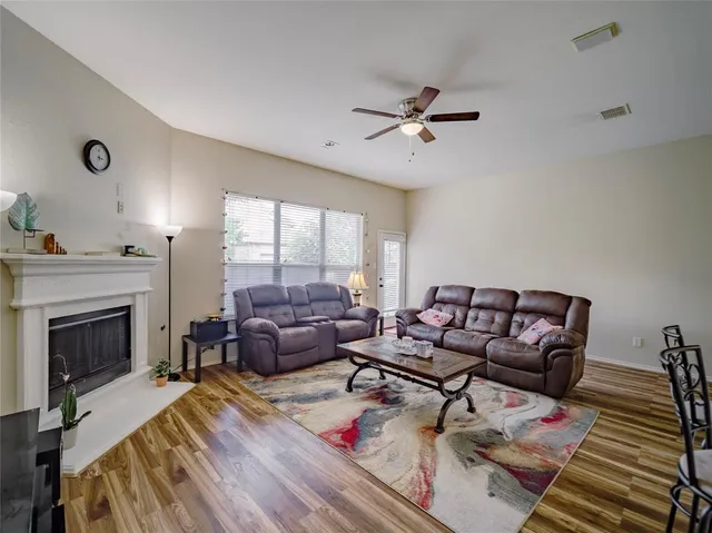 a living room with furniture fireplace and wooden floor