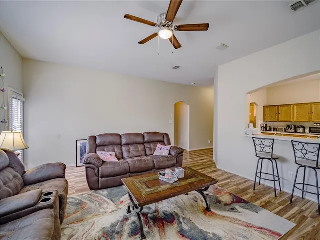 a living room with furniture and a wooden floor